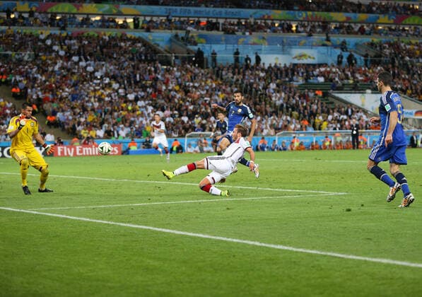 Football - 2014 FIFA World Cup, WM, Weltmeisterschaft, Fussball - Final - Germany v Argentina 13 July 2014 - FIFA World Cup - Final - Germany v Argentina - Mario Gotze of Germany scores the winning goal as Ezequiel Garay (L) and Martin Demichelis of Argentina (R) look on - Photo: Marc Atkins Offside. Rio de Janeiro Brazil Copyright: xMarcxAtkinsxOffside