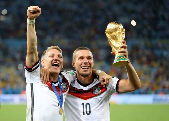 Football - 2014 FIFA World Cup, WM, Weltmeisterschaft, Fussball - Final - Germany v Argentina 13 July 2014 - FIFA World Cup - Final - Germany v Argentina - Bastian Schweinsteiger and Lukas Podolski of Germany celebrate with the world cup - Photo: Marc Atkins Offside. Rio de Janeiro Brazil Copyright: xMarcxAtkinsxOffside