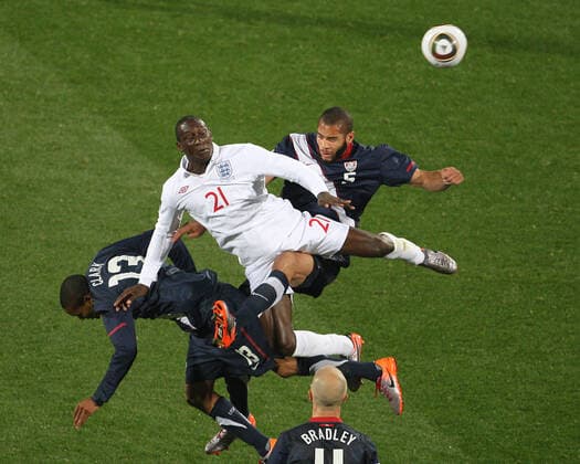 England v USA 12 06 2010 World Cup football. England v United States of America. Emile Heskey jumps for the high ball against Oguchi Onyewu. Photo: Mark Leech. Rustenburg South Africa