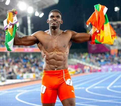 Sport Bilder des Tages 5th August 2022; Alexander Stadium, Birmingham, Midlands, England: Day 8 of the 2022 Commonwealth Games: Lindon Victor (GRN) with his national flag and shirtless after winning the Gold Medal in the Men s Decathlon  ActionPlus12414735 RolandxHarrison