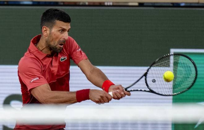 (240529) -- PARIS, May 29, 2024 -- Novak Djokovic hits a return during the men s singles first round match between Novak Djokovic of Serbia and Pierre-Hugues Herbert of France at the French tennis tournament at Roland Garros in Paris, France, on May 28, 2024. ) (SP)FRANCE-PARIS-TENNIS-FRENCH OPEN-MEN S SINGLES MengxDingbo