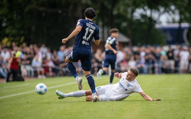 Fussball, Saison 2024 2025, Niederrheinpokal 20.08.2023, 01. Runde, Herren, BW Dingden (weiss) vs. MSV Duisburg (schwarz) v.l.: Mert Goeckan (MSV Duisburg), Lasse Hoffmann (BW Dingden), Hamminkeln Sportanlage BW Dingden Nordrhein-Westfalen Deutschland