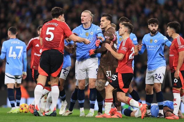 Manchester City v Manchester United, ManU 15 December 2024 - Premier League - Manchester City v Manchester United - Kyle Walker of Manchester City lies on the floor as rival players Erling Haaland of Manchester City and Harry Maguire of Manchester United scuffle around him - Photo: Simon Stacpoole Offside. Manchester UK Copyright: xSimonxStacpoolexOffside