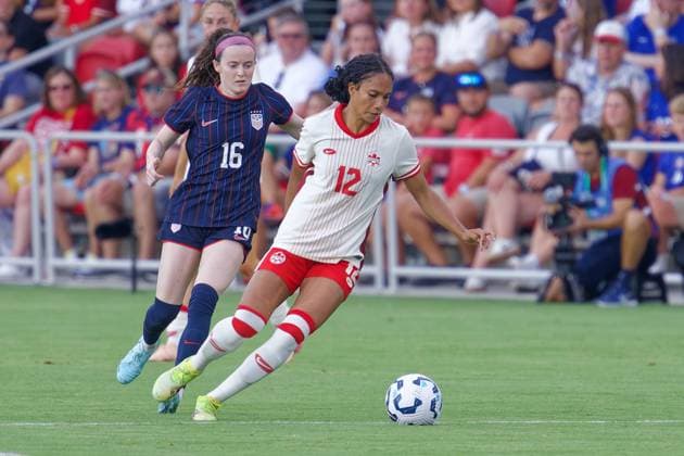 July 2, 2025, Washington, District of Columbia, USA: Jade Rose 12 of Canada drives past Rose Lavelle 16 of the United States during the US Woman™s national team, Nationalteam vs. Canada match at Audi Field. The USA won 3-0. Washington USA - ZUMA 20250702_mda_s363_178 Copyright: xJeffxScudderx