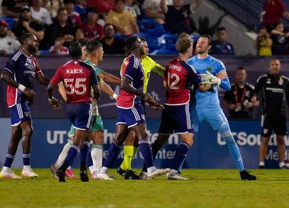 September 13, 2025, Frisco, Texas, USA: FC Dallas midfielder CHRISTIAN CAPPIS (12) attempts to separate Austin FC goalkeeper BRAD STUVER (1) from other players during an argument that resulted in Stuver receiving a yellow card during a Major League Soccer match between FC Dallas and Austin FC on September 13, 2025, in Frisco, Texas. FC Dallas won, 2-0. Frisco USA - ZUMAc201 20250913_zap_c201_098 Copyright: xScottxColemanx