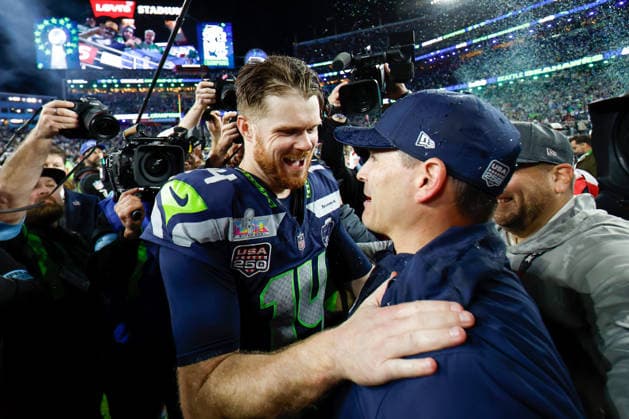 Seattle Seahawks quarterback Sam Darnold left, embraces Seattle Seahawks head coach Mike MacDonald right, after the Seattle Seahawks defeated the New England Patriots to win Super Bowl LX at Levi s Stadium in Santa Clara, California on Sunday, February 8, 2026.  SBP20260208215 JOHNxANGELILLO