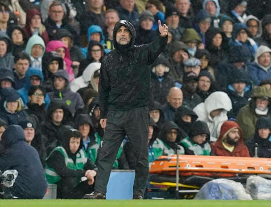 Manchester, England, 13th May 2026. Pep Guardiola coach of Manchester City takes cover from the heavy rain during the Manchester City vs Crystal Palace Premier League match at the Etihad Stadium, Manchester. Picture credit should read: Andrew Yates Sportimage EDITORIAL USE ONLY. No use with unauthorised audio, video, data, fixture lists, club league logos or live services. Online in-match use limited to 120 images, no video emulation. No use in betting, games or single club league player publications. SPI_021_AY_Man_City_Palace SPI-4799-0021