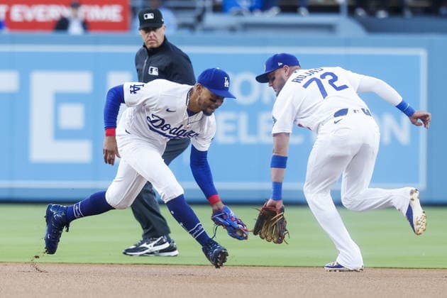 MLB, Baseball Herren, USA - Los Angeles Dodgers vs San Francisco Giants Dodgers shortstop Mookie Betts (L) and second baseman Miguel Rojas (R) field a ball during the first inning of an MLB game between the Los Angeles Dodgers and the San Francisco Giants at Uniqlo Field at Dodger Stadium in Los Angeles, California, USA, 13 May 2026. LOS ANGELES CALIFORNIA United States  Copyright: xCHRISxTORRESx