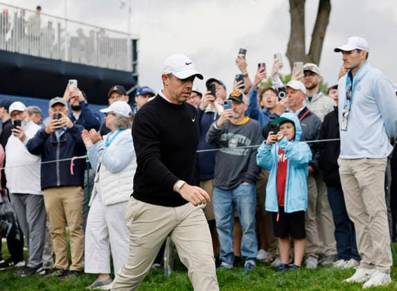Rory McIlroy of Northern Ireland walks past spectators as he prepares to tee off on the 11th hole during the first round of the 2026 PGA, Golf Herren Championship at Aronimink Golf Club in Newtown Square, Pennsylvania, on Thursday, May 14, 2026.  PHI20260514834 LAURENCExKESTERSON