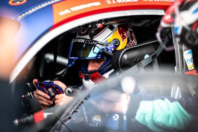 Im Cockpit des Mercedes-AMG GT3 von Mercedes-AMG Team Verstappen Racing sitzt Max Verstappen mit Red-Bull-Helm und blickt konzentriert auf ein Steuergerät in seinen Händen. Auf dem Fahrzeugdach sind die Fahrernamen J. Gounon und D. Juncadella zu lesen. Das Interieur zeigt Carbon-Details, Sicherheitsgurte und das typische GT3-Cockpit-Ambiente. Die Szene vermittelt die intensive Vorbereitung vor dem Rennen am Nürburgring. Max Verstappen im Cockpit des Mercedes-AMG GT3 3 am Nürburgring Copyright: xMichaelxGelhardtx