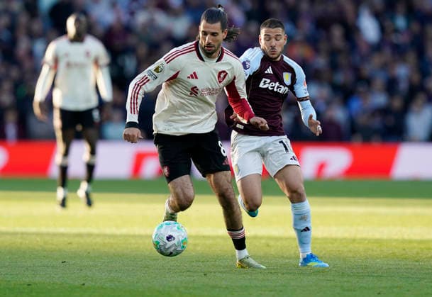Birmingham, England, 15th May 2026. Dominik Szoboszlai of Liverpool (L) is challenged by Emiliano Buendia of Aston Villa during the Aston Villa vs Liverpool Premier League match at Villa Park, Birmingham. Picture credit should read: Andrew Yates Sportimage EDITORIAL USE ONLY. No use with unauthorised audio, video, data, fixture lists, club league logos or live services. Online in-match use limited to 120 images, no video emulation. No use in betting, games or single club league player publications. SPI_010_AY_ASTON_VILLA_LIVERPOOL SPI-4802-0010