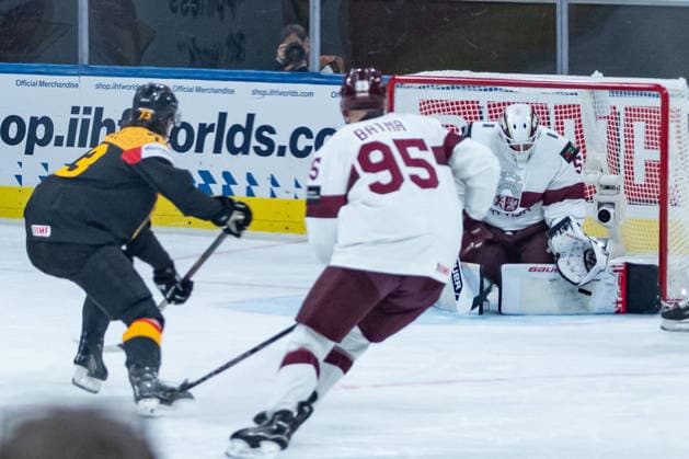 ZURICH, SWITZERLAND - MAY 17: Kristers Gudlevskis (Latvia, 50) keeps the shot from Lukas Reichel (Germany, 73) during the Preliminary Round - Group A Match 15 between Germany and Latvia at the IIHF Ice hockey, Eishockey World Championship, WM, Weltmeisterschaft 2026, Swiss Life Arena on May 17, 2026 in Zurich, Switzerland. Zurich Switzerland Copyright: xTimoxSteinx