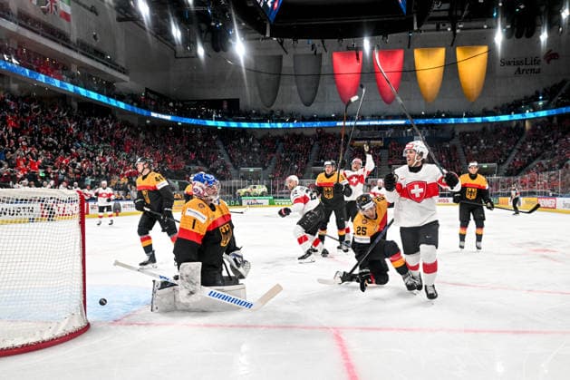 ZURICH, SWITZERLAND - MAY 18: Christoph Bertschy of Switzerland R) celebrates his goal scored against goalkeeper Jonas Stettmer of Germany L) during the 2026 IIHF Ice hockey, Eishockey World Championship, WM, Weltmeisterschaft Switzerland game between Germany and Switzerland at Swiss Life Arena on May 18, 2026 in Zurich, Zurich. Zurich Swiss Life Arena Zurich Switzerland Copyright: xJustPictures.ch AndreaxBrancax jp-en-EuSpIm-JP7_ANB_Ger_Sui_18052026_5519