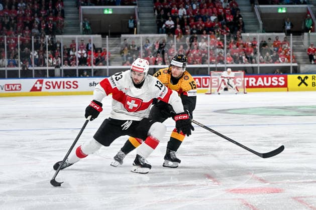 ZURICH, SWITZERLAND - MAY 18: Nico Hischier of Switzerland protects the puck from Stefan Loibl of Germany during the 2026 IIHF Ice hockey, Eishockey World Championship, WM, Weltmeisterschaft Switzerland game between Germany and Switzerland at Swiss Life Arena on May 18, 2026 in Zurich, Zurich. Zurich Swiss Life Arena Zurich Switzerland Copyright: xJustPictures.ch AndreaxBrancax jp-en-EuSpIm-JP7_ANB_Ger_Sui_18052026_2232