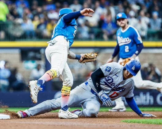 Los Angeles Dodgers designated hitter Shohei Ohtani (R) steals second base on Milwaukee Brewers shortstop Joey Ortiz (L) in the first inning of the MLB, Baseball Herren, USA game between the Los Angeles Dodgers and the Milwaukee Brewers at American Family Field in Milwaukee, Wisconsin on Friday, May 22, 2026.  MIL20260522809 TANNENxMAURY