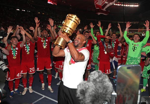 Fussball, Herren, DFB-Pokal Finale, Saison 2025 2026, FC Bayern München - VFB Stuttgart, Olympiastadion Berlin Die Mannschaft des FC Bayern München feiert den Gewinn des DFB-Pokal hier nach dem Spiel, im Bild Vincent Kompany, Trainer (FC Bayern München) mit dem Pokal beim Jubeln vor der Fankurve DFB, DFL regulations prohibit any use of photographs as image sequences and or quasi-video