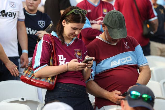 West Ham v Leeds 24 May 2026, London - Premier League Football - West Ham United v Leeds United - West Ham fans check their phones for the score in the Tottenham fixture - Photo: Charlotte Wilson Offside. London UK Copyright: xCharlottexWilsonx xOffsidexOffside