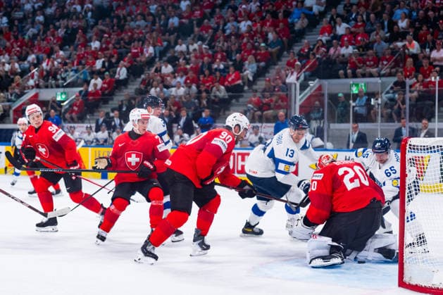 ZURICH, SWITZERLAND - MAY 26: Jesse Puljujaervi (Finland, 13) and Sakari Manninen (Finland, 65) trying to score against Reto Berra (Switzerland, 20) during the Preliminary Round - Group A Match 55 between Switzerland and Finland at the IIHF Ice hockey, Eishockey World Championship, WM, Weltmeisterschaft 2026, Swiss Life Arena on May 26, 2026 in Zurich, Switzerland. Zurich Switzerland Copyright: xTimoxSteinx