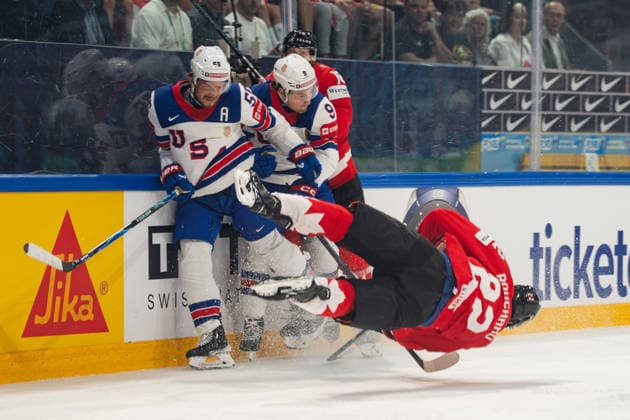 FRIBOURG, FRIBOURG - MAY 28: Evan Bouchard of Canada is checked by Ryan Lindgren of the United States during the 2026 IIHF World Championship, WM, Weltmeisterschaft quarterfinal match between Canada and the United States at BCF Arena on May 28, 2026 in Fribourg, Fribourg, Switzerland. Copyright: xLivioxBaeriswylx xSPPx Sportspressphoto_SPR156127