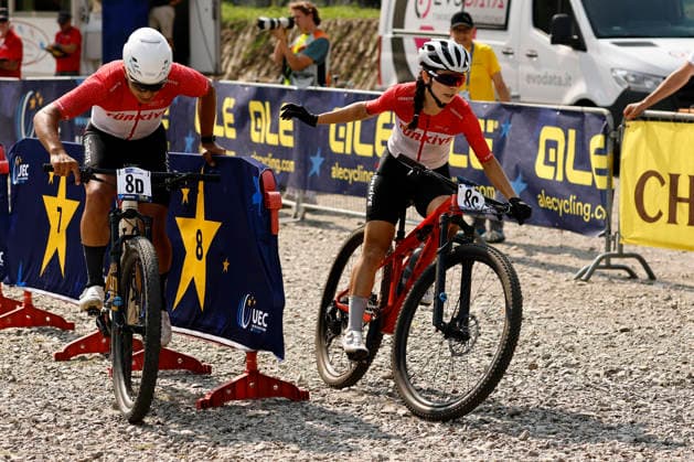 31.07.2026, Monteceneri, Monte Ceneri, 2026 UEC MTB European Championship, EM, Europameisterschaft XCR Team Relay s Final (cross country team relay) Azize Bekar 8C (TUR, Elite Women) launching Eren Gecim 8D (TUR, Junior Men) Monteceneri Monte Ceneri Ticino Switzerland Copyright: xJustPictures.ch FrancescoxMinghettix jp-en-FrMi-_NG_0688