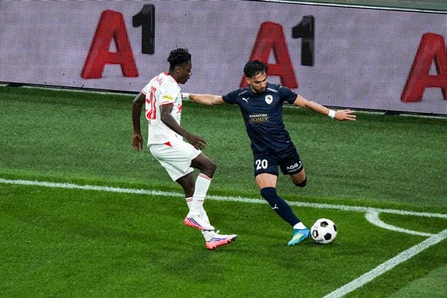 Fussball: Österreich: UEFA Europa League Qualifikation 2026 2027 - 3. Runde, 06.08.2026 - FC Red Bull Salzburg (Österreich) vs. Pafos FC (Zypern) - Red Bull Arena (Wals-Siezenheim, Österreich); Edmund Baidoo (FC Salzburg), Gabriel Biel (Pafos FC) Copyright: xLUKAxKOLANOVICx