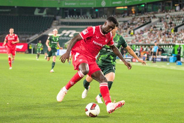 08.08.2026 Fußball Herren 2026 2027 2. Bundesliga 1. Spieltag VfL Wolfsburg - 1. FC Kaiserslautern Volkswagen Arena Wolfsburg Maxwell Gyamfi (Kaiserslautern, 4, rot) schirmt den Ball vor Kento Shiogai (Wolfsburg, 7, grün) ab. Wolfsburg Niedersachsen Deutschland