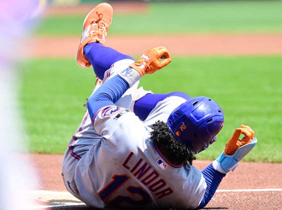 New York Mets shortstop Francisco Lindor (12) rolls on the dirt after being hit by a pitch from Pittsburgh Pirates pitcher Jared Jones in the first inning at PNC Park on Sunday, August 9, 2026 in Pittsburgh.  PIT2026080903 ArchiexCarpenter