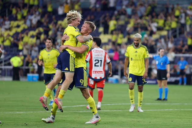 NASHVILLE, TN - AUGUST 09: Nashville SC midfielder Edvard Tagseth (20) jumps into the arms of forward Sam Surridge (9) after they connected for a goal during a LeagueÕs Cup match between Nashville SC and AtlŽtico San Luis, August 9, 2026, at GEODIS Park in Nashville, Tennessee. (Photo by Matthew Maxey Icon Sportswire) SOCCER: AUG 09 Leagues Cup Nashville vs Atletico de San Luis EDITORIAL USE ONLY Icon26080909