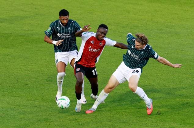 Andrew Oluwabori of Exeter City with Xavier Amaechi and Alex Hartridge of Plymouth Argyle. Plymouth Argyle v Exeter City, EFL Carabao Cup, First Round, Football, Home Park, Plymouth, UK - 10 Aug 2026Plymouth Home Park United Kingdom EDITORIAL USE ONLY No use with unauthorised audio, video, data, fixture lists, club league logos or live services. Online in-match use limited to 120 images, no video emulation. No use in betting, games or single club league player publications. Copyright: xJamesxMarsh Shutterstockx 17061088av