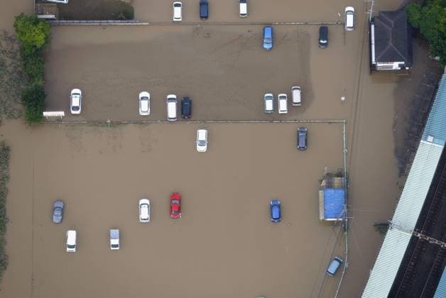 Aftermath of torrential rain in eastern Japan Photo taken from a Kyodo News helicopter on Aug. 14, 2026, shows vehicles submerged in floodwaters in a parking lot in Oamishirasato, Chiba Prefecture, east of Tokyo, after torrential rain overnight. Japan s weather agency issued its highest Level 5 warning in parts of the prefecture.  A14AA0005625773P