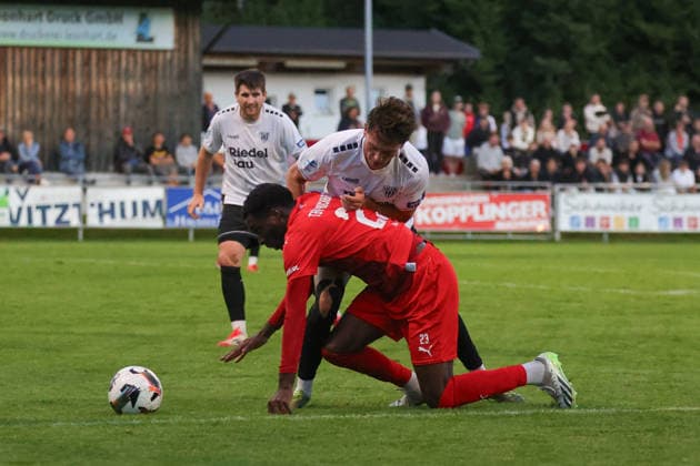 18.09.2026, Fussball, Herren, Saison 2026 2027, Regionalliga Bayern, 10. Spieltag: TSV Buchbach - FC Schweinfurt 05 Von links: Lukas Mrozek (FC Schweinfurt 05, 06) gegen Daniel Muteba (TSV Buchbach, 23) Buchbach SMR-Arena Bayern Deutschland