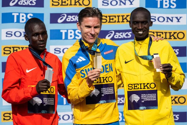 260920 Nicholas Kipkorir of Kenya, Andreas Almgren of Sweden and Joshua Cheptegei of Uganda celebrate on the podium after the Copenhagen Half Marathon in the World Athletics Road Running Championships on September 20, 2026 in Copenhagen. Photo: Mathilda Schuler BILDBYRAN kod MA MA1036 friidrott athletics friidrett world athletics road running championships copenhagen half marathon 2026 bbeng half marathon jubel Copyright: MATHILDAxSCHULER BB260920MA074