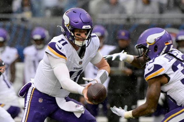Minnesota Vikings quarterback Carson Wentz (11) hands off the ball to Minnesota Vikings running back Aaron Jones Sr. (33) against the Chicago Bears at Soldier Field in Chicago on Sunday, September 20, 2026.  CHI20260920107 MARKxBLACK