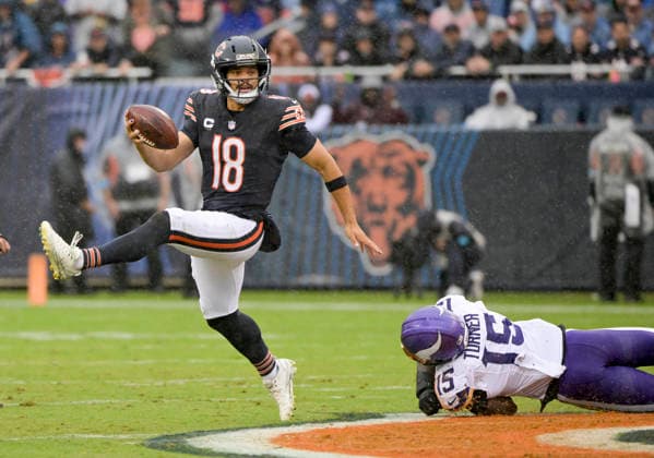 Chicago Bears quarterback Caleb Williams (18) high steps his way away from the tackle by Minnesota Vikings linebacker Dallas Turner (15) during a game at Soldier Field in Chicago on Sunday, September 20, 2026. Vikings defeated the Bear 9-6.  CHI20260920114 MARKxBLACK