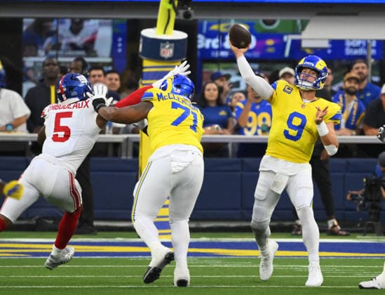 Los Angeles Rams quarterback Matthew Stafford (9) passes over New York Giants cornerback Kayvon Thibodeaux (L) Monday Night Football at SoFi Stadium in Inglewood, California on Monday September 21, 2026.  LAP2026092108 JONxSOOHOO