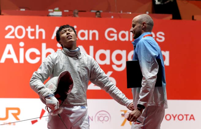 (260923) -- TOKYO, Sept. 23, 2026 -- Shen Chenpeng (L) of China reacts after losing to Oh Sanguk of South Korea during the men s sabre final at the 20th Asian Games Aichi-Nagoya 2026 in Tokyo, Japan, Sept. 23, 2026. ) (SP)JAPAN-NAGOYA-ASIAN GAMES-FENCING-MEN S SABRE INDIVIDUAL-FINAL YaoxQilin 