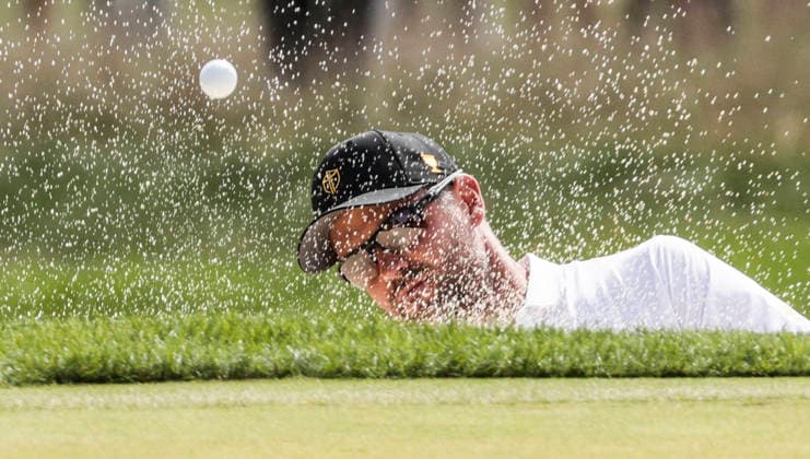 International team member Corey Conners of Canada hits from a bunker on the fourth hole during round one Four-ball play in the Presidents Cup golf tournament at Medinah Country Club in Medinah, Illinois on Thursday, September 24, 2026.  MED20260924838 TANNENxMAURY