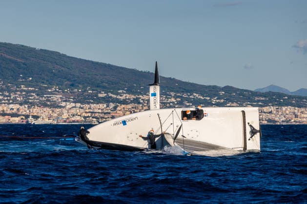 La Roche-Posay Racing Team capsized on the start line for Race 2 of Day 1. Louis Vuitton 38th America s Cup Preliminary Regatta, Naples, Italy. Friday 25 September 2026. Photo: Georgia Schofield NZ Naples Italy Copyright: xx