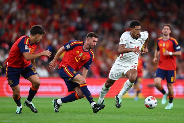 London, England, 26th September 2026. Jude Bellingham of England with the ball under pressure form Aymeric Laporte (C) of Spain during the England vs Spain UEFA Nations League match at Wembley Stadium, London. Picture credit should read: Paul Terry Sportimage EDITORIAL USE ONLY. No use with unauthorised audio, video, data, fixture lists, club league logos or live services. Online in-match use limited to 120 images, no video emulation. No use in betting, games or single club league player publications. SPI_164_PT_England_Spain SPI-5020-0163