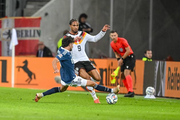 Thanasis Androutsos (Greece) and Kevin Schade (Germany) battle for the ball during the UEFA Nations League 2026 27 group phase match between Germany and Greece at WWK Arena on September 27, 2026 in Augsburg, Germany. (Photo by Harry Langer DeFodi Images) -