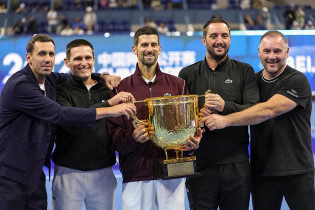 (261006) -- BEIJING, Oct. 6, 2026 -- Winner Novak Djokovic of Serbia poses for photos with his team staff after the awarding ceremony for the men s singles final at 2026 China Open tennis tournament in Beijing, China, Oct. 6, 2026. ) (SP)CHINA-BEIJING-TENNIS-CHINA OPEN-MEN S SINGLES-AWARDING CEREMONY(CN) BaixXuefei 