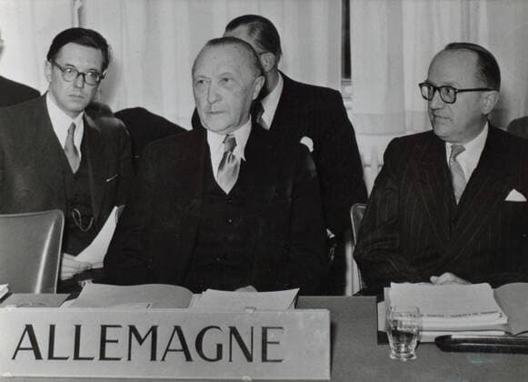 May 02, 1951 - Bonn, Germany - West Germany s first chancellor KONRAD ADENAUER began his career in politics as a member of the Cologne City Council, becoming lord mayor of the city. After the Nazis came to power in 1933, Adenauer, who had not hidden distaste for them, lost his positions, was forced to go into exile for a year in an abbey and was later interned in a prison camp. Adenauer was elected Chancellor of the Federal Republic of Germany on 15 September 1949. His main aim was to ensure West Germany s transition to a sovereign, democratic state. He held power for the next fourteen years and during that time played an important role in restoring good relations with France and the United States. PICTURED: Germany becoming a member of Council of Europe; KONRAD ADENAUER and professor WALTER HALLSTEIN (right) signing the deal. Bonn Germany  - ZUMAk09