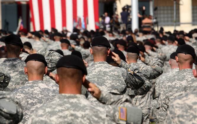 Army soldiers salute for the National Anthem during the III Corps and Fort Hood Memorial Ceremony, held to honor the 13 victims of the November 5 shootings in Killeen, Texas on November 10, 2009.  DFW2009111007