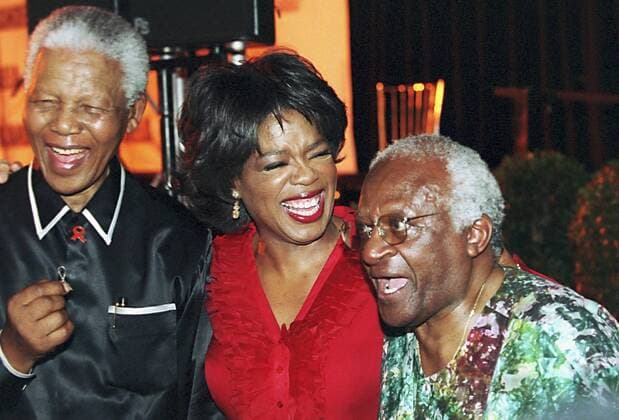 7 December 2002 Former South African president Nelson Mandela (L), American talkshow host Oprah Winfrey and Archbishop Desmond Tutu share a joke at the Kirstenbosch Botanical Gardens in Cape Town, where the Nelson Mandela SOS to the world project is being launched. Gallo000033500