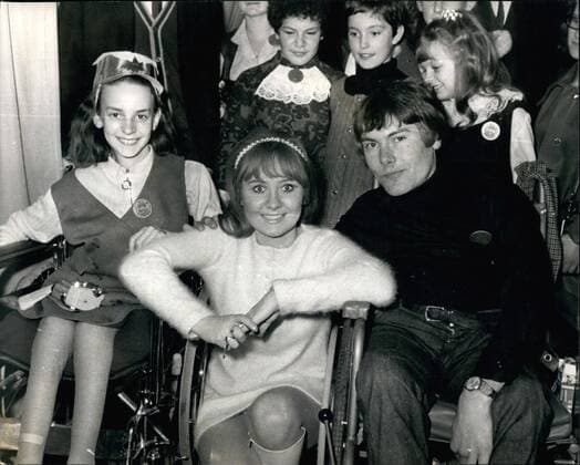 Dec. 12, 1968 - Lulu - voted the world s top Female singer Holds Christmas party for 150 fans. Lulu- who is to represent Britain in the Eurovision songs contest - and has been voted the world s top female singer, today gave a Christmas party for 150 of her fans at Manchester Square, London, W.1. Photo Shows Lulu, the 20-year-old singer from Glasgow, is pictured with two of her fans in wheelchairs, Elizabeth Tanner, aged 13, from Bristol, and Norman Storar, 21, from Gloucester, at today s Christmas party.  - ZUMAk09