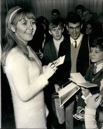 Dec. 12, 1968 - LULU - VOTED THE WORLD S TOP FEMALE SINGER HOLDS A CHRISTMAS FOR 150 FANS LULU - who is to represent Britain in the Eurovision song contest - and recently voted the world s top female singer, today gave a Christmas party for 150 fans at Manchester Square, London W.L. PHOTO SHOWS: Lulu, the 20-year-old singer from Glaegow, signs autograph. for some of the fan. who attended today Christmas party,  - ZUMAk09