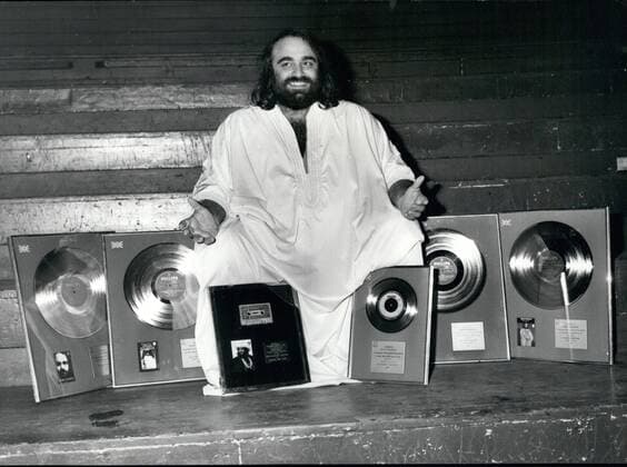 Oct. 10, 1976 - International singing star Demis Roussos is presented with Gold and Silver awards at the Royal Albert Hall: International singing star, Demis Roussos, was last night awarded a silver disc for his L. P. Fire and Ice , denoting U. K. sales exceeding ?100,000: gold discs for his L. P. s Happy to be , My only Fascination and Souvenirs , denoting U. K. sales exceeding ?250,000; also a siver disc for exceeding 250,000 copies; plus a gold cassette for Forever and ever , the album of which has been gold in the U. K. for over a year. The awards were presented to Demis at the end of his 3rd sell-out concert at the Royal Albert hall last night. Photo shows Demis Roussos pictured with his award at the Royal Albert Hall last night. - ZUMAk09