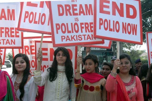 Pakistani women hold placards during a rally to mark World Polio Day in eastern Pakistan s Lahore on Oct. 24, 2014. World Health Organization said Friday that three more polio cases have surfaced in Pakistan, bringing the number of new cases to 220, a record figure that authorities blame on attacks by insurgents targeting vaccination teams. )(zhf) PAKISTAN-LAHORE-POLIO DAY-RALLY Sajjad 