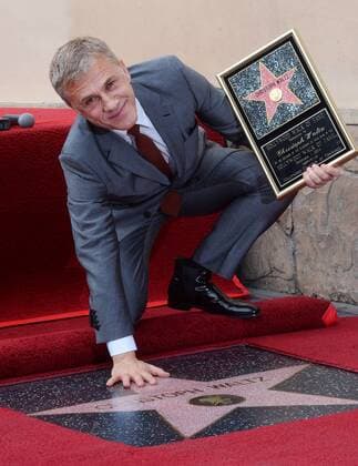 Actor Christoph Waltz holds a replica plaque during an unveiling ceremony honoring him with the 2,536th star on the Hollywood Walk of Fame in Los Angeles on December 12, 2014.  LAP2014120107