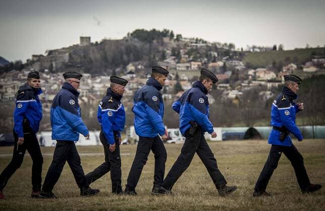 (150325) -- SEYNE, March 25, 2015 -- French gendarmes walk in the rescue base camp in the Alps in southern France, March 25, 2015. French gendarmes late Tuesday found one of the two black boxes of the German passenger plane that crashed in southern France with 150 people on board, while a joint international probe into the cause of the accident is under way. ) FRANCE-SEYNE-AIRBUS A320 CRASH-RESCUE ChenxXiaowei 